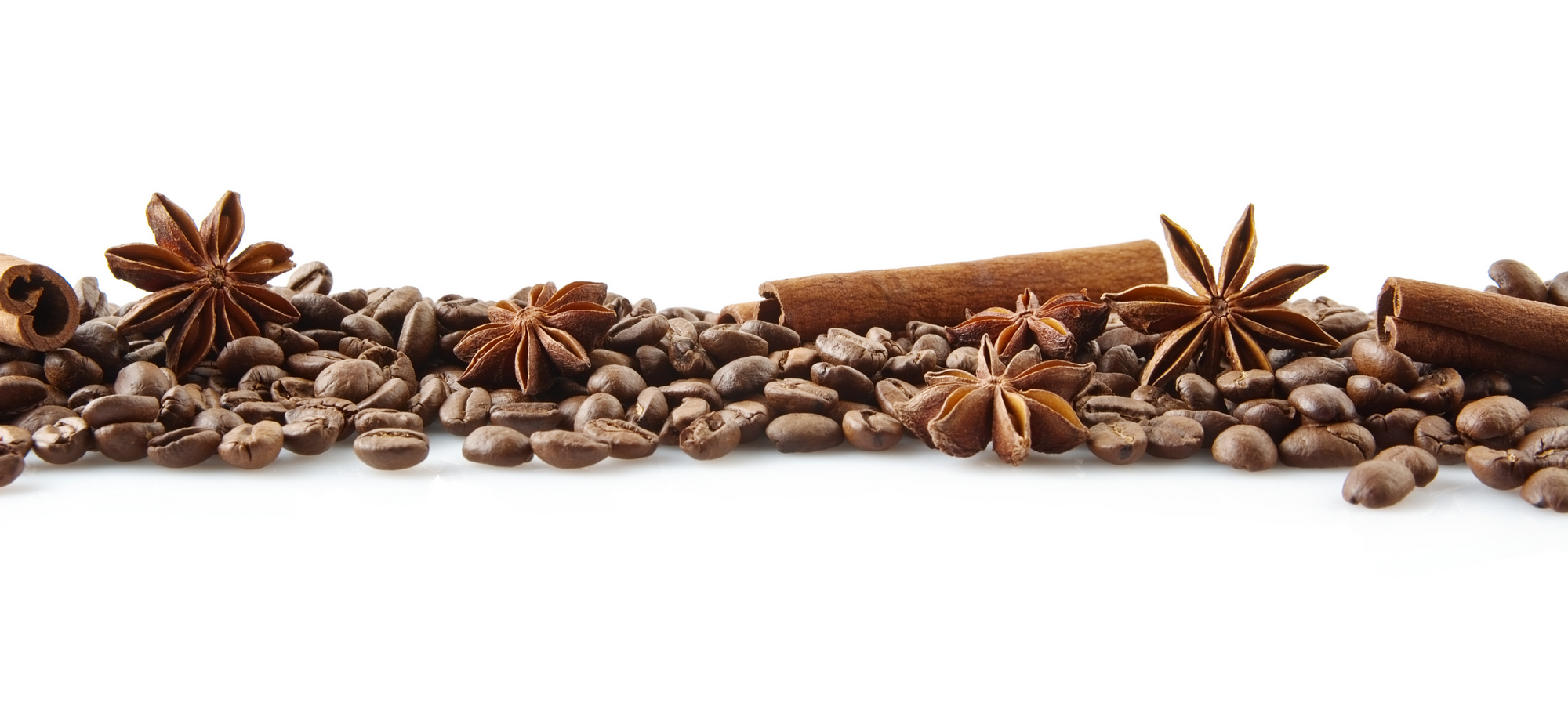 luwak Coffee beans, star anise, and cinnamon sticks arranged in a decorative pattern on a white background